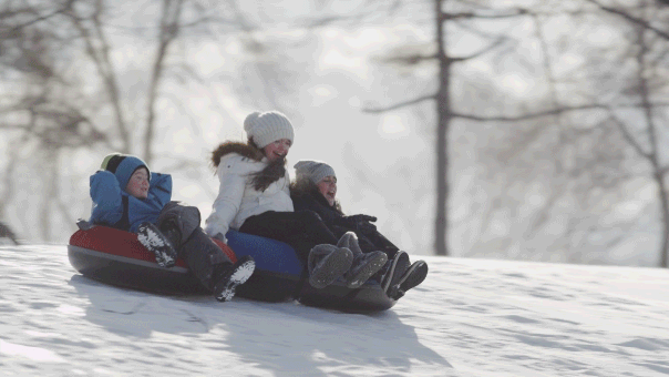 Children playing outside in fresh snow, building snowman and having fun together