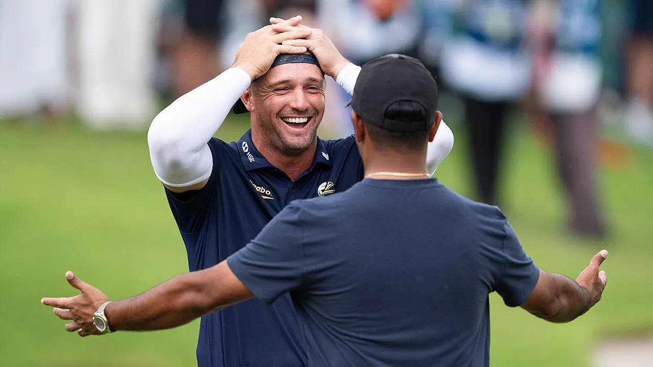 Bryson DeChambeau holding trophy and celebrating victory at LIV Golf Singapore tournament