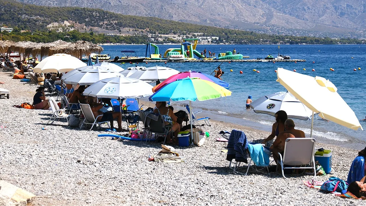 Pristine Greek beach with crystal blue water and natural coastline without commercial development