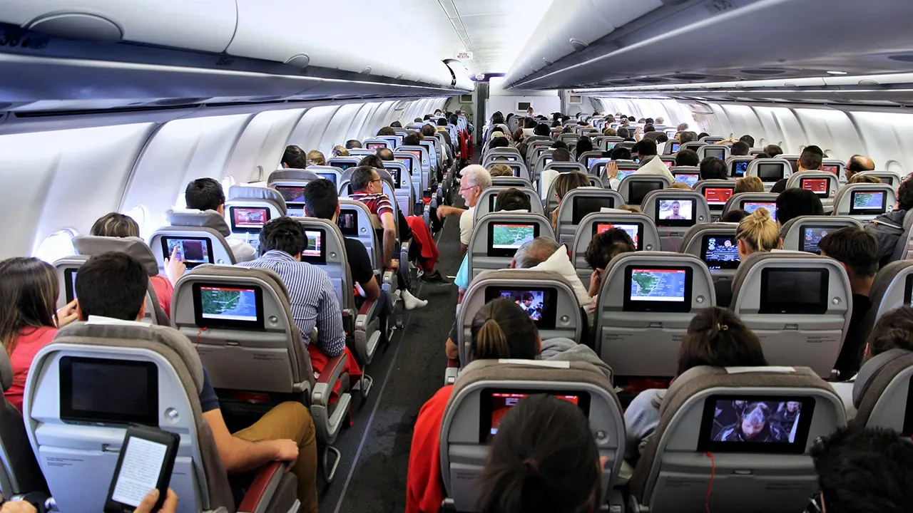 Passengers sitting peacefully in airplane cabin during comfortable flight experience