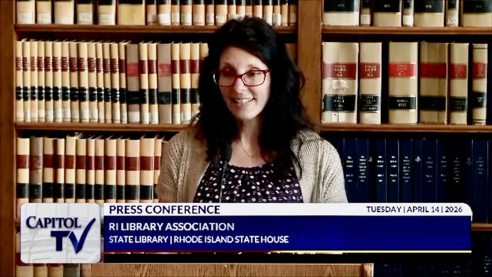 School librarian Natasha White stands at podium in Rhode Island State House Library