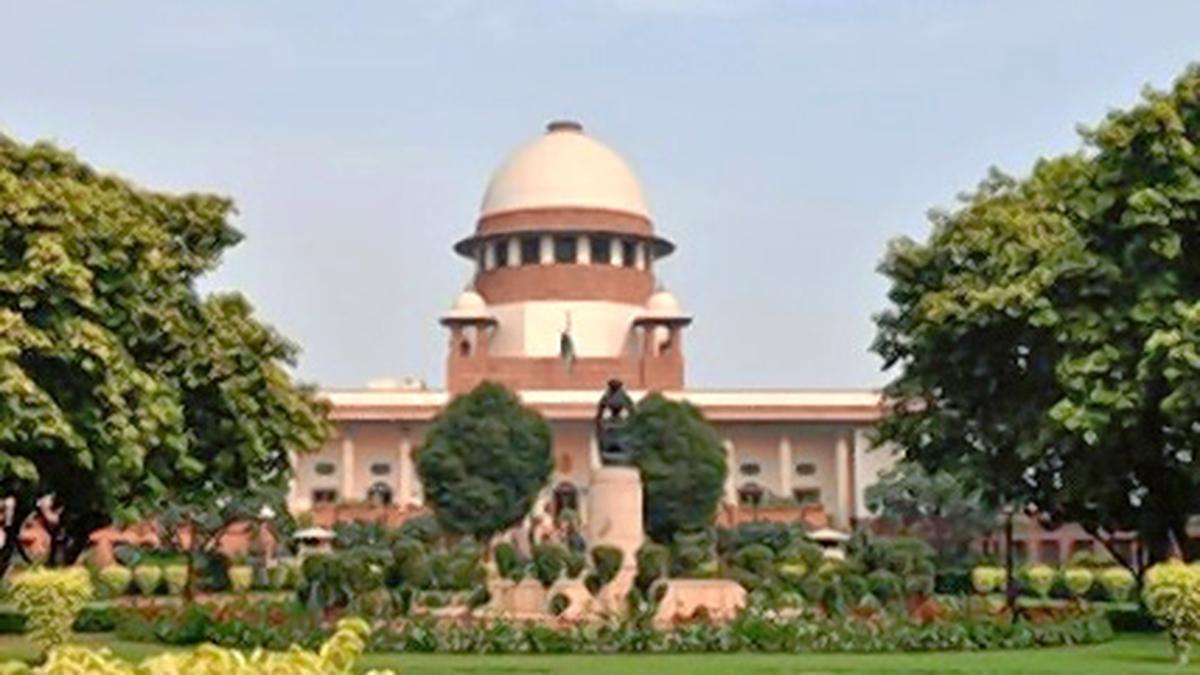 Exterior view of India's Supreme Court building with national flag flying above