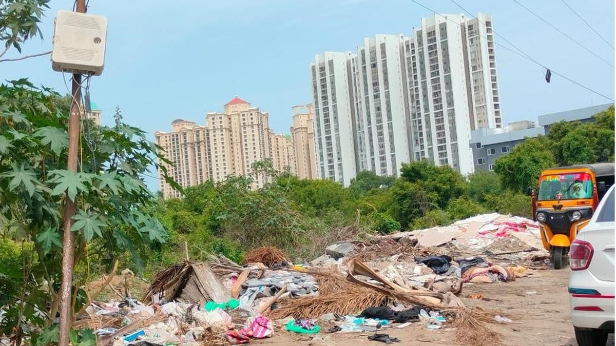 Waste collection truck serving large apartment complex in Chennai, India, representing improved city sanitation