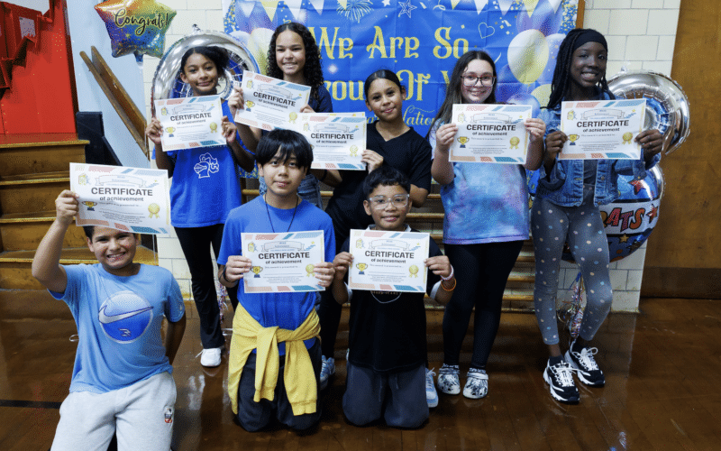 Students and staff at Midland Street Elementary School celebrate School of Recognition achievement with banners