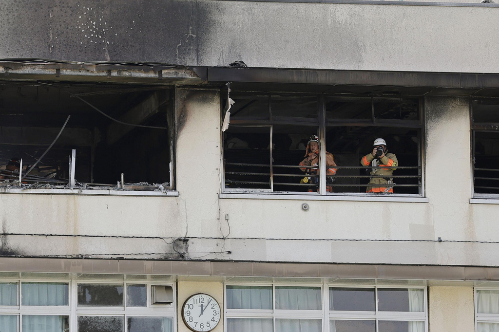 Firefighters work at Tokyo elementary school with smoke billowing from upper floor windows