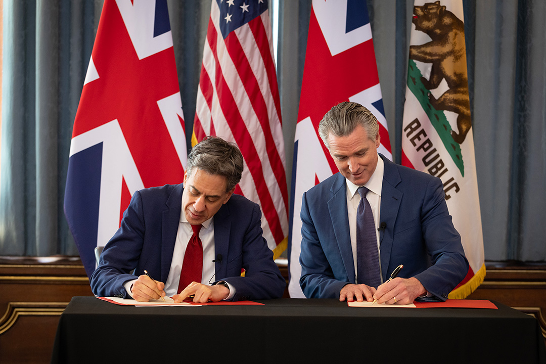 Governor Newsom and UK Energy Secretary Ed Miliband shake hands after signing climate partnership agreement