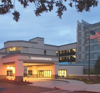 Medical professional reviewing detailed 3D brain scan images on computer monitors in hospital