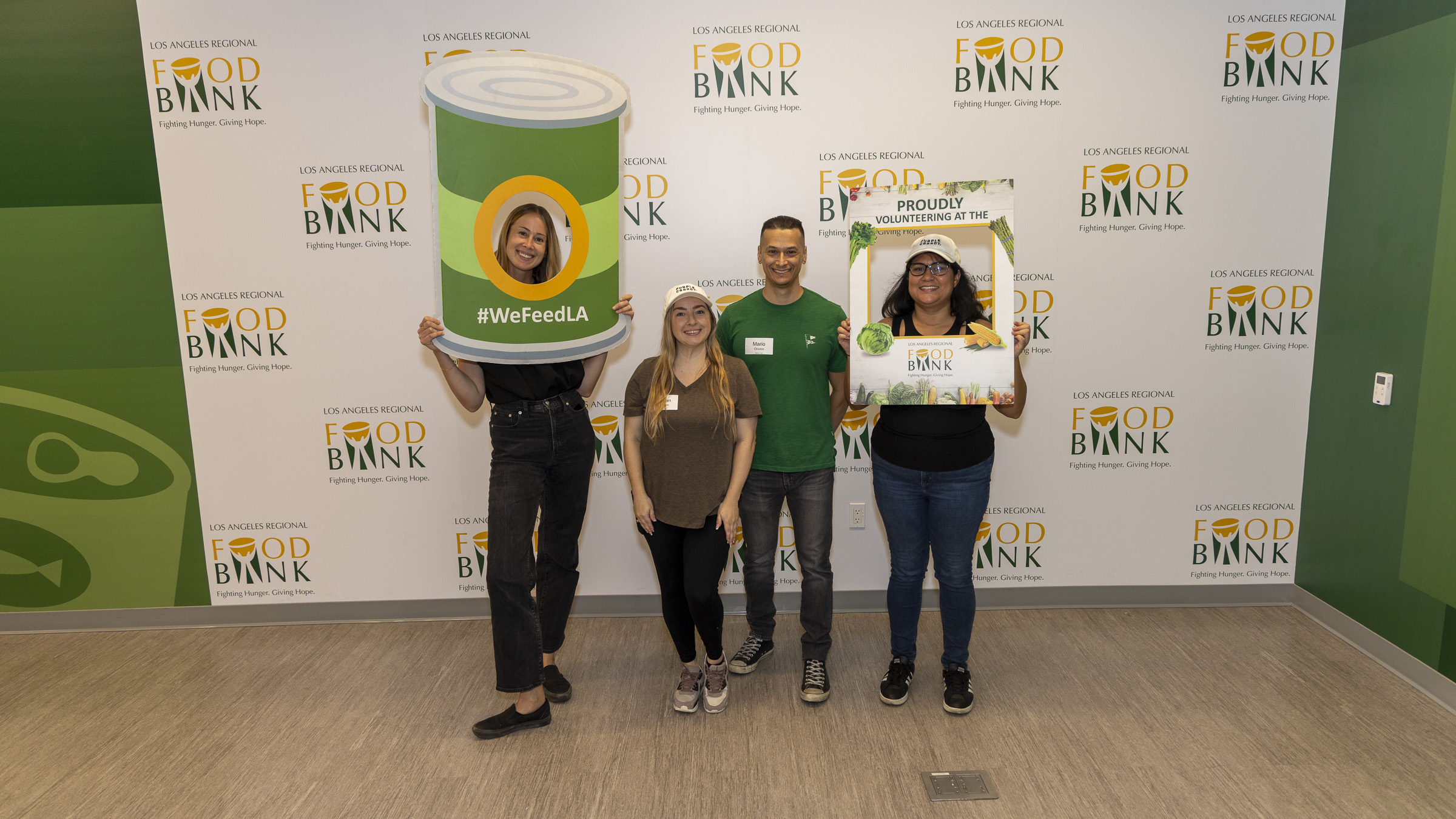 ** Diverse group of volunteers sorting and packing food donations at Los Angeles Regional Food Bank warehouse