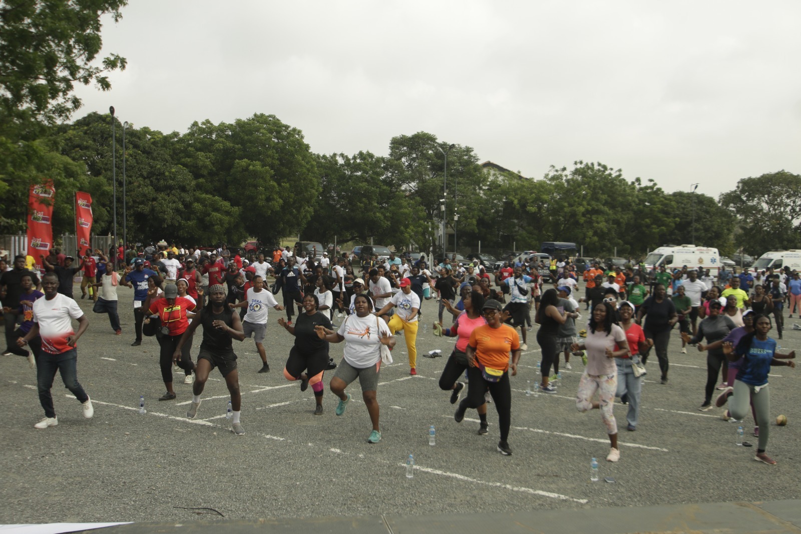Large group of fitness enthusiasts walking together through Accra streets during Joy FM Big Workout event