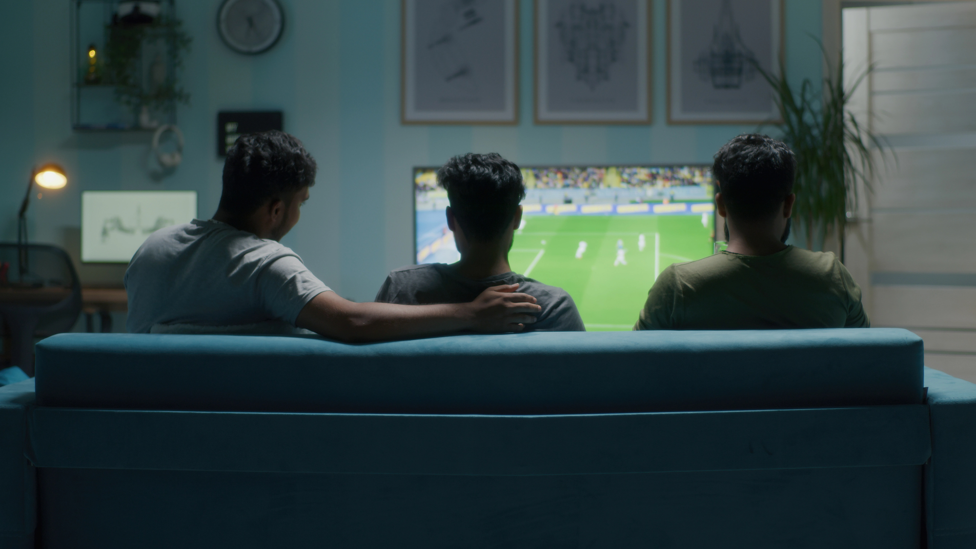 Soccer fans in stadium cheering intensely during match showing physical engagement and excitement