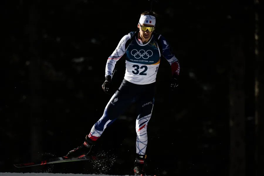 Biathlon athlete Fabien Claude celebrating at summit of Mount Tongariro volcano in New Zealand