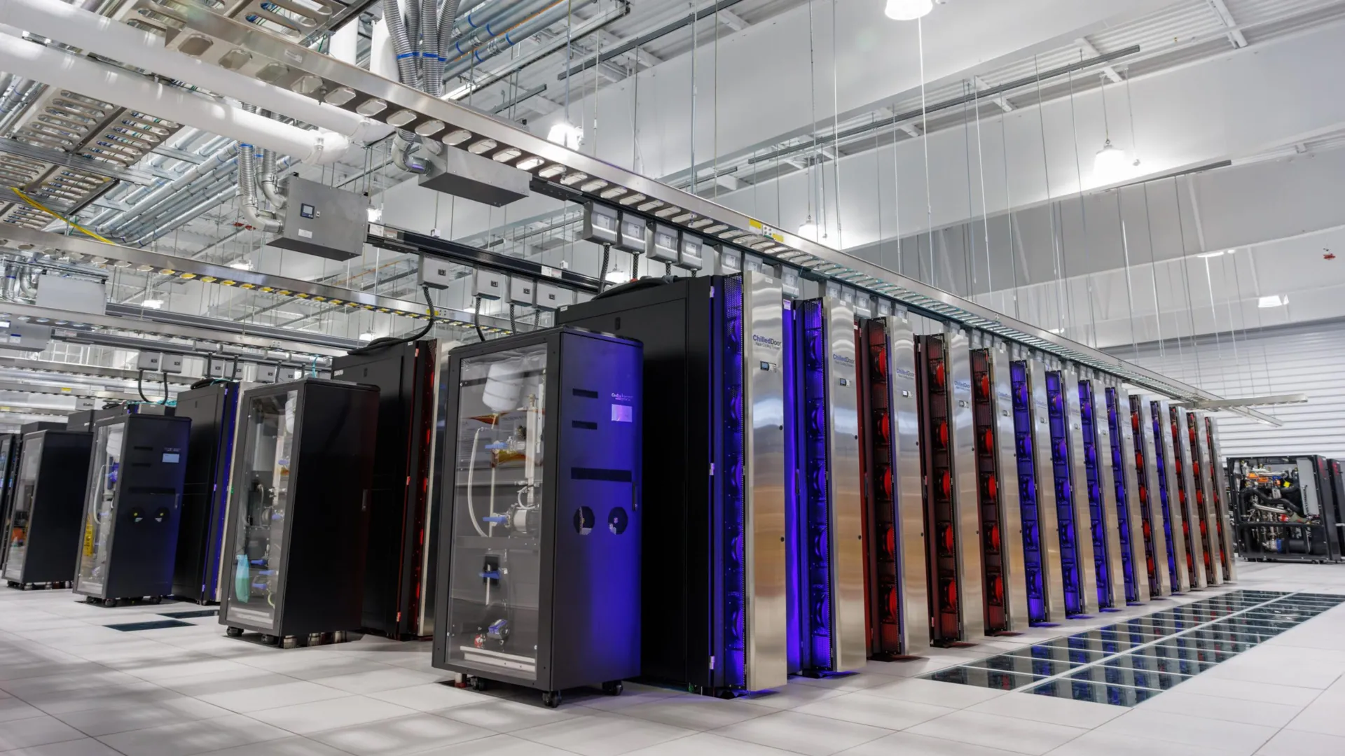 Large data center facility with rows of computer servers consuming significant electrical power