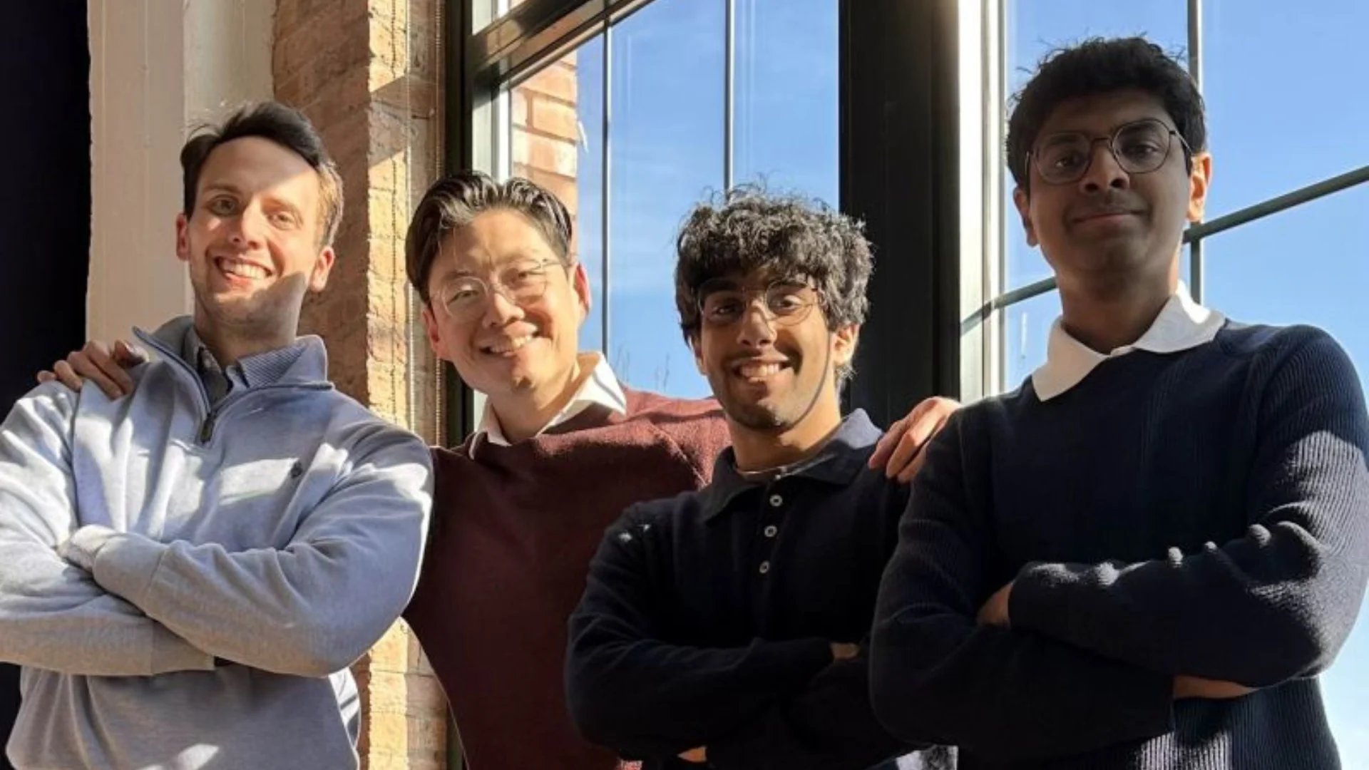 Four Auvi Labs founders standing together in front of window at medical facility