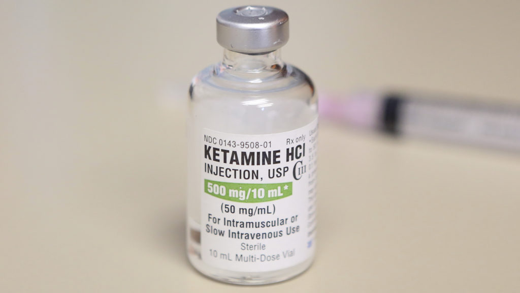 Medical research setting where ketamine therapy and psychological coaching are being studied for depression treatment
