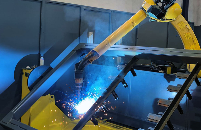 Precision robotic arm welding structural steel components for high-rise building facades in modern factory