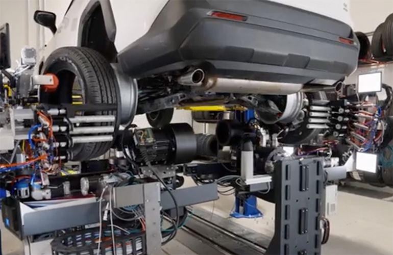 Robotic SmartBay system changing vehicle tires from underneath while wheels remain attached